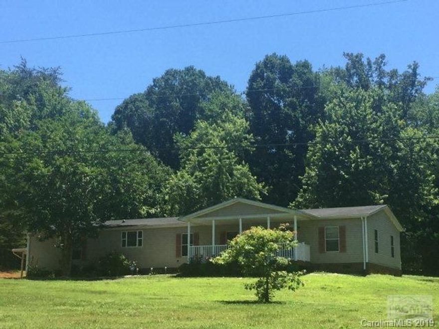 Large manufactured home on level lot with carport and storage building.  Brick foundation and lovely landscaping.  Move in ready!