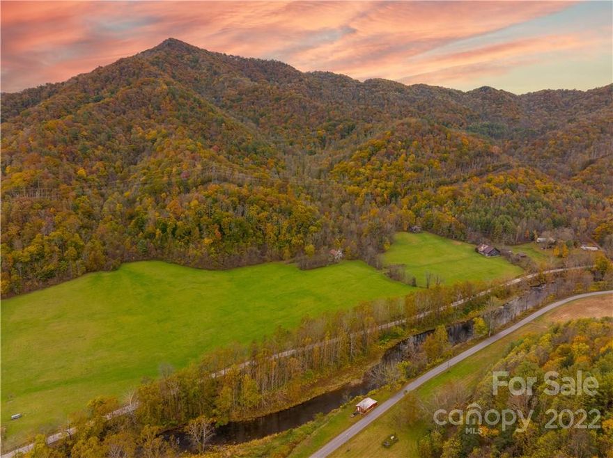 690+/- Acre estate with over 2,800ft of RIVERFRONT and 29+/- acres of FLAT pasture land fit for livestock or any farming you desire! This gorgeous property has many neat features, including an ATV trail system throughout, a sizable barn in great condition for storing farm equipment & accessories, multiple peaceful hollows with spectacular views for miles, & an early 1900's church that is still in restorable shape making this the PERFECT location for a wedding venue! This HUGE private tract has multiple streams, teaming with wildlife, and many locations for you to build your dream home. While this property is secluded, you are still only 20 minutes from Burnsville & just under an hour from the beautiful Asheville. NC. Photos and video honestly doesn't do it justice, you truly have to experience this BIG slice of heaven for yourself! Shown by APPOINTMENT ONLY! Be sure to contact the listing agent or office as there is a caretaker on the property that needs notified before showing!