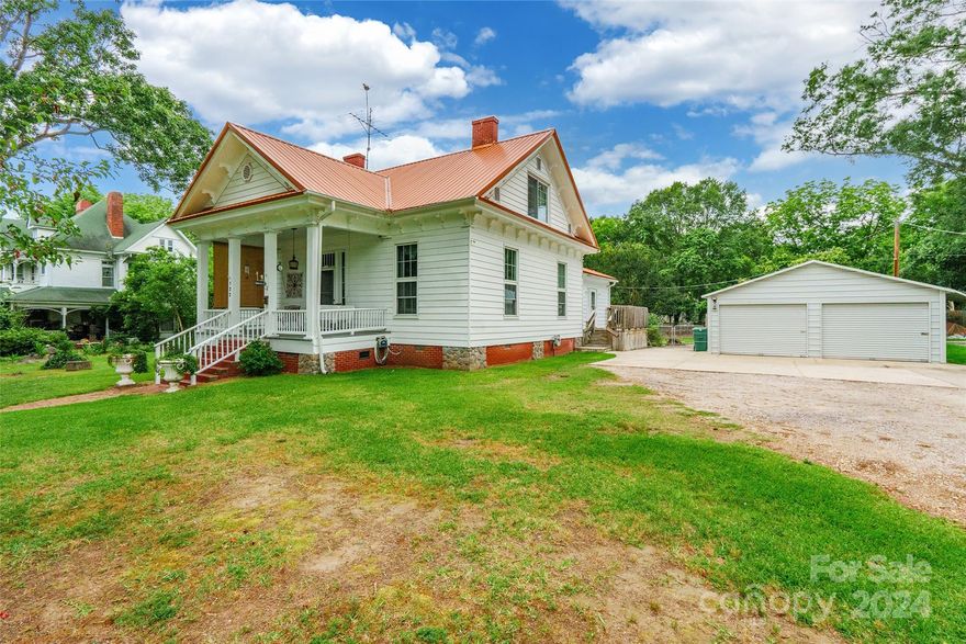 Nestled on a spacious lot, this charming 4 bedroom, 1.5 bath home exudes warmth & character. Impeccably maintained, the interior boasts a large foyer with an original staircase up to the 2nd floor. There is an eat in kitchen, beautiful dining room with built in electric fireplace, two nice sized bedrooms, and both bathrooms all on the first floor. Up the staircase are 2 additional bedrooms & a loft, which is great for an office or play area. The gleaming wood floors create a seamless flow, providing a timeless & inviting ambiance. The crawl space is thoughtfully encapsulated for added durability & peace of mind. The roof was replaced in 2020 with a metal roofing. With 2 generously sized garages, measuring 20x20 and 24x24, both wired with electricity & an additional outbuilding, this property offers ample space for your hobbies, or storage needs. Don't miss the chance to make this adorable & well-maintained home yours! Hot tub on back porch is negotiable.