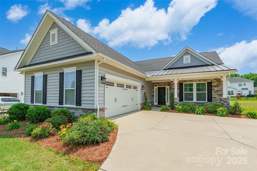 Absolutely beautiful home that checks all the boxes! From the inviting curb appeal and covered front entry to the gorgeous raised panel details and wainscoting in the foyer, every element is thoughtfully designed. Step into a bright and open floor plan where the kitchen features white cabinets, granite countertops, stainless steel appliances, a pantry, and opens seamlessly to the great room with large windows and a gas log fireplace. The split bedroom layout offers privacy, while the spacious primary suite includes a huge shower with a built-in bench, two linen closets, and generous closet space throughout. Upstairs you will find a third bedroom with its own full bath, perfect for guests or a private retreat. Enjoy neutral colors, blinds throughout, and a move in ready feel. Additional features include a tankless water heater, HUGE walk in attic for storage, and access to a beautiful community pool.