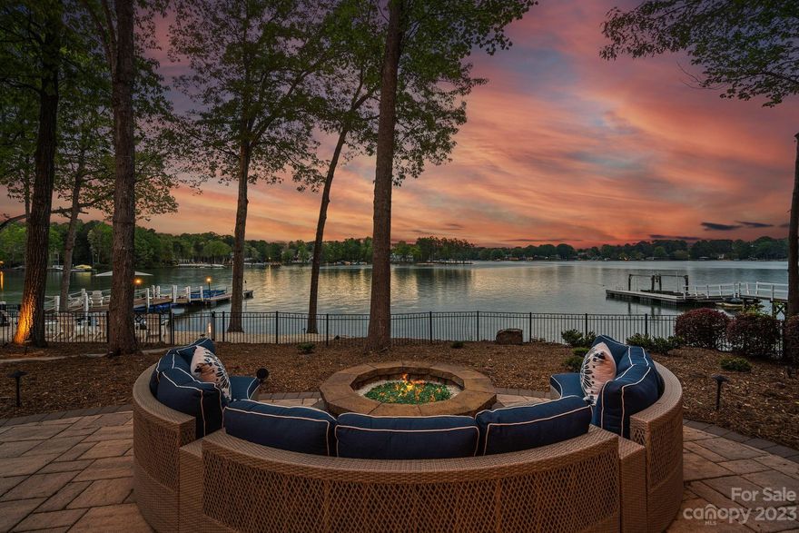 Professionally designed renovation has taken this impressive 3-level waterfront home w/long range lake views to the next level! A circular driveway, charming courtyard w/fountain create a grand entrance. Inside, the foyer opens to an expansive lake view that is shared by many of the rooms in the home. The main level primary is a retreat w/fireplace & porch. A well-appointed kitchen opens onto a keeping room w/fireplace, screened porch and terrace. The sunroom features a friends’ entrance & elevator to all levels. Dual staircases lead to upper-level w/3 ensuite bedrooms, a private library w/fireplace & versatile bonus room w/full bath and wet bar. Enviable lake level w/wine cellar, bar, entertaining areas, fireplace, full bath & 2nd laundry. Lake side fun includes saltwater pool/spa, fire/ice firepit, gazebo w/outdoor kitchen, white sand beaches w/paddle board launch area and private pier w/boat slip & seating deck. Located in The Point Village & walkable to club amenities & events.
