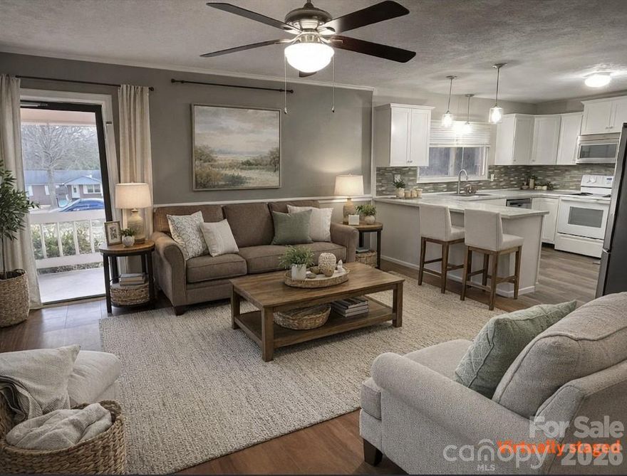 Classic charm meets modern comfort. From the moment you arrive, the rocking chair front porch invites you to slow down and enjoy this brick ranch with carport. Features timeless hardwood floors in both bedrooms and the dining area. Lots of updates you’ll also appreciate coming home to include the following: opened up the kitchen to the living room to improve flow for entertainment and daily living. Kitchen updates include kitchen cabinets, tiled backplash, counter tops, sink, faucet, and appliances (refrigerator remains), as well as the flooring in the kitchen, living room and bath. But wait, there’s more! Added new architectural roof (2021), and replaced the old fuse box with a modern breaker panel (2023). In addition to all of those updates, owners also replaced the bath vanity, the garden doors to the deck, as well as the deck top boards overlooking the fenced back yard where there’s a large wired storage building with an enclosed ground level shed on the rear for lawn and garden equipment. All of this country living with private well and septic (meaning no city utilities), and added financial benefit of no city taxes. Near Stanley, but with a Dallas mailing address. Come on home!