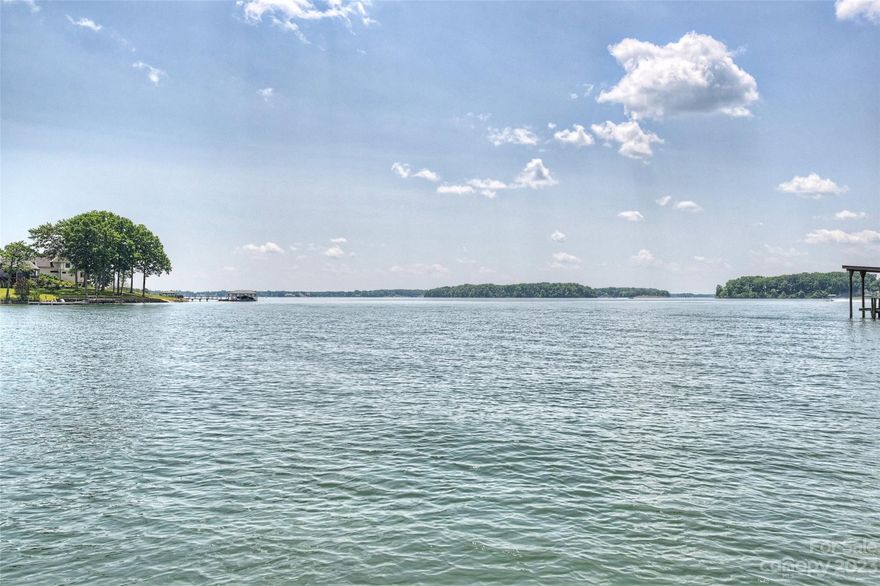 A great opportunity on Lake Norman with amazing views.  Situated in Iredell County, Mooresville.  No HOA!  This .75 acre lot is private with many mature trees. Very very close to the main channel with a shoreline that is just shy of 200' with existing rip rap.  Boathouse that is grandfathered in, two boat ramps and a private pier.  Build your dream home or renovate the existing cottage.  Perfect for a basement style home.  This property has so many opportunities.  Sit back, relax and take in the spectacular views of Lake Norman.