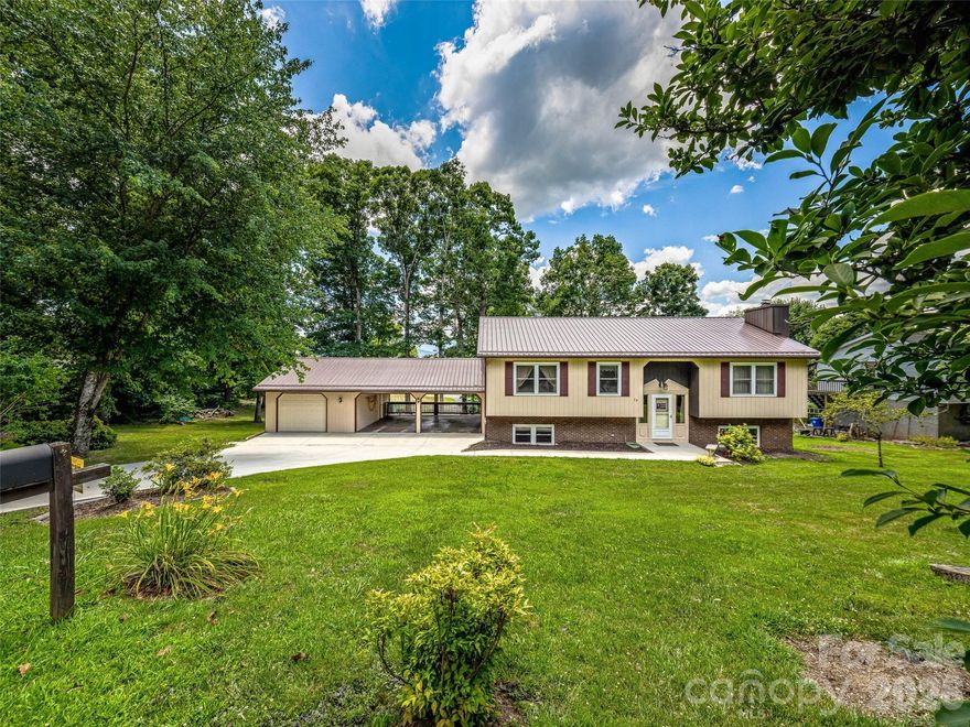 Motivated sellers! Don’t miss this chance to scoop up this great value in a prime location! Fantastic mid-century, ranch style home with beautiful hardwood floors, seasonal Mountain views! Located on a quiet cul-de-sac on nearly ½ acre. Bring all the toys! RV, camper, boat, or extra vehicles - versatile NEW cement oversized driveway, two carports, and a garage. The spacious open kitchen boasts center island, new flooring, pantry and bar. INCOME OPPORTUNITY - The lower level features a brand-new kitchenette, living area with cozy wood-burning stove, two bedrooms, and full bath, separate level entry, separate key access, and a paved walk-out patio leading to an expansive private yard. Ideal for mother-in-law apartment, teens & guests! Short- or long-term rental OK! Major updates include NEW roof, NEW HVAC, NEW exterior paint, freshly painted bathrooms and more! Easy access to I-40 & Blue Ridge Pkwy, West Asheville, Downtown AVL, Biltmore Park, shopping, and dining. MUST SEE!