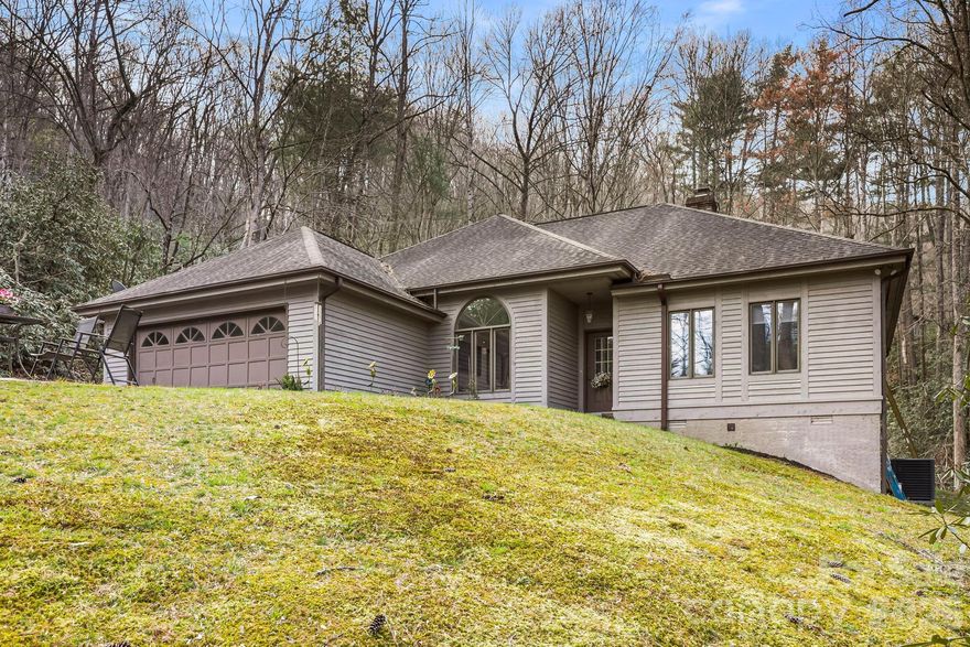 Welcome to 446 Silver Fox Lane, a charming and thoughtfully designed home nestled at the end of a quiet cul-de-sac in the highly sought-after Fox Crossing community of Pisgah Forest. Set on a private lot, this property offers the perfect combination of peaceful mountain living and everyday convenience. Inside, you’ll find a bright, open living space highlighted by vaulted ceilings and large windows. The split-bedroom floor plan provides ideal separation, with a spacious primary suite tucked away for privacy and comfort. Two additional bedrooms offer generous space for guests, family, or a home office. The home is designed for easy one-level living, featuring low-maintenance finishes, an attached garage, and a flat driveway for effortless access. Step out back to enjoy the private deck—perfect for morning coffee, evening relaxation, or entertaining while surrounded by nature and tucked away in your own oasis. Located just minutes from Pisgah National Forest and DuPont State Forest, outdoor adventure is always within reach. You’re also just a short drive to downtown Brevard, where you can enjoy local dining, shopping, and a vibrant small-town atmosphere. Whether you’re looking for a full-time residence or a peaceful second home, this property offers comfort, privacy, and an unbeatable location.