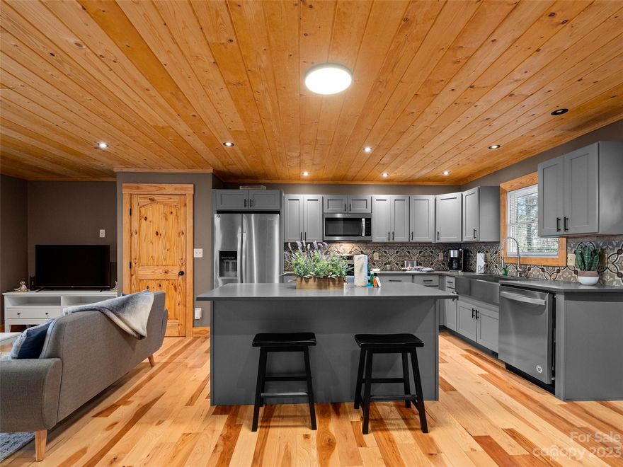 This lovely, renovated home is located less than 2 miles from downtown Brevard. Enjoy all the convenience without paying city taxes! The open floorplan boasts beautiful hardwood floors and tongue-in-groove ceilings throughout. The modern kitchen has custom cabinets, quartz counters, gorgeous tiled backsplash and stainless appliances. The quiet cul-de-sac neighborhood is a welcoming retreat for a primary home, short term rental investment or a second home.  This charming home is the perfect combination of style, location and accessibility. Schedule your showing today!