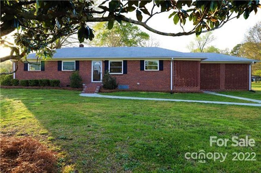 Welcome home to this beautiful 3 bed, 1 bath brick ranch-style home on a corner lot in Chester, SC. New heater, new ductwork, new garage door (2020), and new windows (2014). Custom kitchen cabinets. All appliances will remain including washer/dryer. Spacious fenced-in backyard, wired storage building, and a brick fireplace in the screened-in porch area. Bonus: Low county taxes! No HOA!