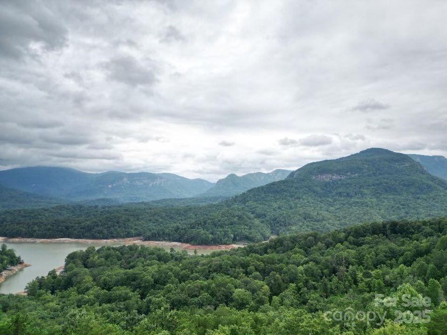 Waterfront Building site on 1.06+- acres inside the Main Gate at Rumbling Bald on Lake Lure.  Lovely Mountain Views and wooded privacy.  Expired 5BR Septic Permit.  Just a short golf cart ride to the Private Community Beach, Wellness Center, Restaurants, Pools, and Golf Course.  Right of way across neighboring lot provides access to likely building site.  Excellent opportunity to own your personal lake front lot to construct your dream home!  (Neighboring Lot 5 also available for purchase - Check with listing Agent for details).