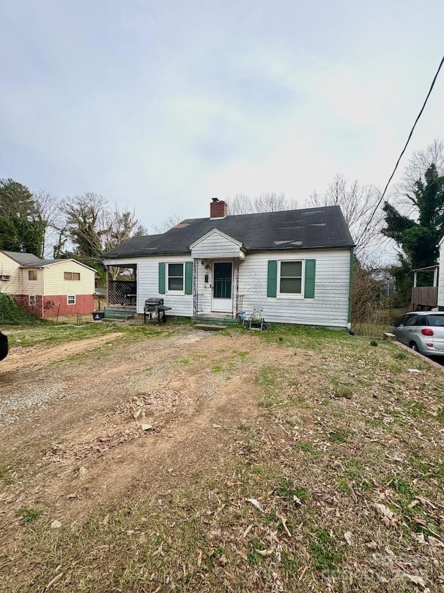 Great Investment Opportunity - selling AS IS condition - Comfortable 2 bedroom cottage with spacious walk out basement that's partially finished with 2 bonus rooms. Great workspace area. Need interior/exterior remodel. Has insulated windows. Spacious kitchen with built ins and breakfast area; access door to deck. Comfortable living room w/ wood burning fireplace. Spacious bedrooms. Has side and front covered porch & deck. Ready for your personal touch. Seller motivated for a quick sale. Month to month occupant. Please do not disturb. No sign in yard. Call to further discuss property. Easy interstate & downtown access. Gas meter on lot.