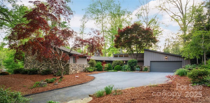 Rare mid-century single-level masterpiece in Biltmore Forest.  Designed by renowned architect Lawrence Traber in 1977 and exquisitely renovated in 2014. From the main entrance you are greeted by sweeping open spaces with tall ceilings that extend from the spacious gourmet kitchen, and the intimate dining area, revealing two distinct living areas, each with it's own wood burning fireplace. The home is drenched in soft sun-light from a wall of glass that flanks the entire back and opens to outdoor terraces. This home was designed with casual yet elegant spaces for relishing time together with friends and family.  Inviting and intimate open spaces that inspire!  Outside areas were designed to be maintenance free with large trees, evergreens, perennials, stone paths and parapets. It's coveted location borders Greenwood Park, and is a short walk to the Blue Ridge Parkway, the Mountain to Sea Trail and the expansive twenty five acre campus of Carolina Day School.