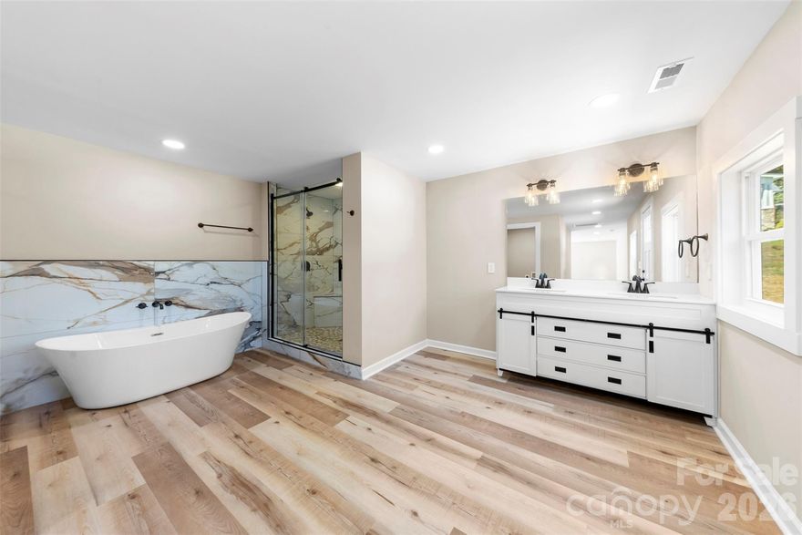 Welcome home to this beautifully renovated 3-bedroom, 2-bathroom home offering over 1,800 sq ft of comfortable living space on more than half an acre. You'll  love the open floor plan filled with natural light and the thoughtful split-bedroom design that gives everyone their own space. The living room features an electric fireplace that adds the perfect touch of warmth, while the open flow makes it easy to gather with family and friends. The primary suite is truly a retreat, complete with a walk-in closet accented by barn doors and double doors leading out to a private deck where you can sip your morning coffee. The spa-inspired bathroom feels like your own personal getaway with double vanities, a large tiled walk-in shower, a soaking tub, and a private water closet. You’ll also love the convenience of having the laundry room right in the suite. The other bedrooms are spacious and inviting, each with easy access to a beautifully updated bathroom. Every detail of this home has been carefully refreshed, from the updated finishes to the bright, welcoming spaces. Step outside and enjoy over half an acre of land—perfect for relaxing, entertaining, or creating the backyard you’ve always dreamed of. Back on the market due to no fault of the seller.