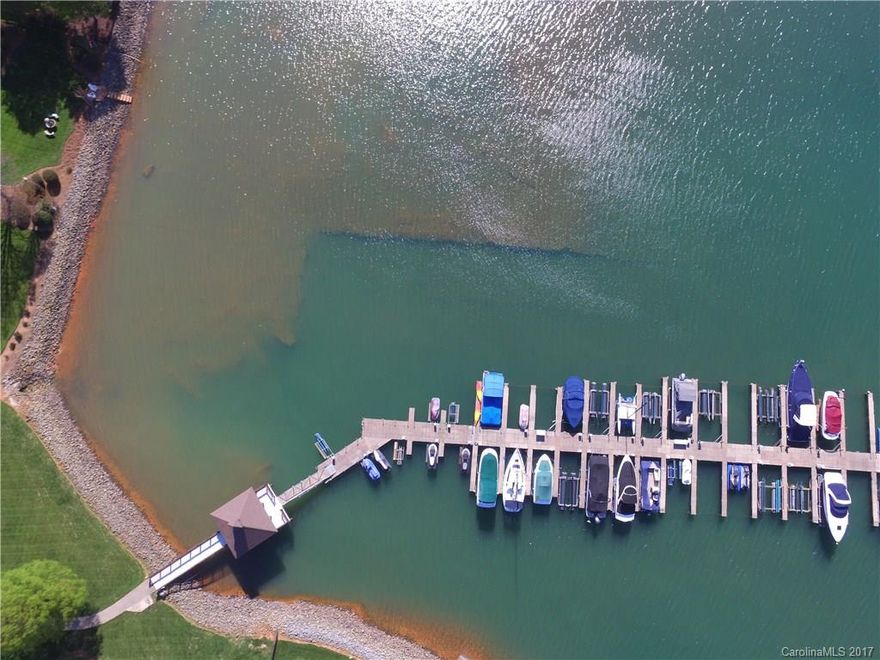 Lakefront community w/Deeded Boat slip, Brick and HC Stucco with BR and full bath on main and 3 BR up w/ 3 full baths . Custom built home with very open plan, large kitchen updated w/Granite, backsplash, ss appliances, updated baths, travertine flooring, granite. Large Master Suite w/ walk in closet. Lush landscaped yard w/ privacy plantings and flowers. Convenient to Birkdale Village, 77 and more,  southern tip of Lake Norman for lake life closest to Charlotte! Double Charleston style porches !