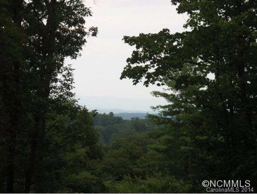 Private mountain estate only 15mins from Dtwn Asheville and ready for house plans. 3 possible home sites have been cleared; road has been put in and electric. Mountain views; hiking trails; babbling creek and a pond. Shed and work area located by primary clearing at top of the road. Property can be subdivided. Country living, but close to all Asheville amenities.