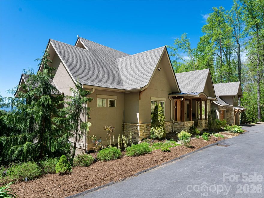 Stunning Reynolds Mt. home located on 3.5 acres complete with private hiking/walking trails. Offering privacy with western facing sunset views of the Blue Ridge Mts from every room. Level driveway, 3 car garage with electric charging station, elevator. Open Great Room with Chef's Kitchen, two bedroom suites on main floor allows complete main level living if desired. Guest apartment located above the garage with sleeping for six. Kitchenette. Separate entrance allows complete privacy from main house. Two guest suites, family room with fireplace and private deck on lower level. Whole house generator, professional landscaping. Reynolds Mt. is located in desirable north Asheville near Grocery Store Row, and 10 minutes from downtown Asheville galleries.