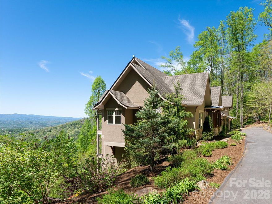 Stunning Reynolds Mt. home located on 3.5 acres complete with private hiking/walking trails. Offering privacy with western facing sunset views of the Blue Ridge Mts from every room. Level driveway, 3 car garage with electric charging station, elevator. Open Great Room with Chef's Kitchen, two bedroom suites on main floor allows complete main level living if desired. Guest apartment located above the garage with sleeping for six. Kitchenette. Separate entrance allows complete privacy from main house. Two guest suites, family room with fireplace and private deck on lower level. Whole house generator, professional landscaping. Reynolds Mt. is located in desirable north Asheville near Grocery Store Row, and 10 minutes from downtown Asheville galleries.
