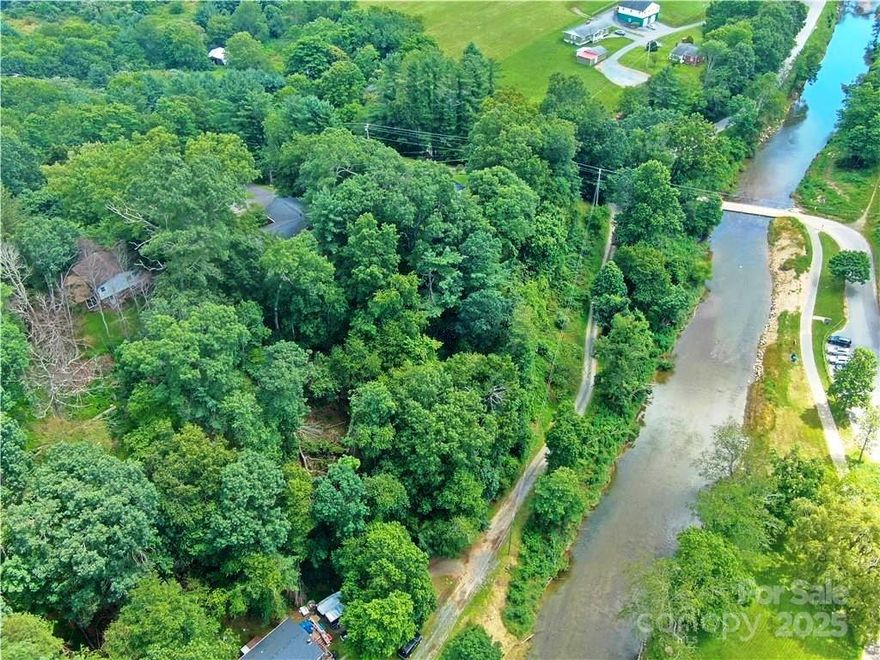 Over 500 ft of New River frontage. Land starts in wooded area just past 384 house and goes to Casey Lane, down to the New River and on both sides of the shared driveway along the river front. Build on the slope above the river to overlook the river and nearby hills. Build on the slope across from the river and overlook the river and nearby hills. This 2.42 acre parcel is outside the Town limits, but has the ability to access Town water. It comes with shared well rights. The Boone Greenway begins just across the river and there is easy access via Casey Lane. Both short term and long term rentals are allowed. There are many possibilities on what could be built on this property, but No mobile homes are allowed.