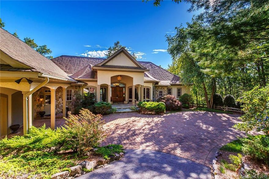 This absolutely magnificent 4BR/5.5 bath home is situated on a stunning view site on Hawk Mountain overlooking Lake Toxaway and Toxaway Mountain.  Beautiful sunset views can be seen from almost every room of this home that features 4 fireplaces, spectacular Chef's kitchen with double ovens, gas cooktop, Butler's pantry, octagonal screened porch, large master suite with two closets, lower level with outstanding entertaining area and bar, and large bonus room with full bath above the garage.