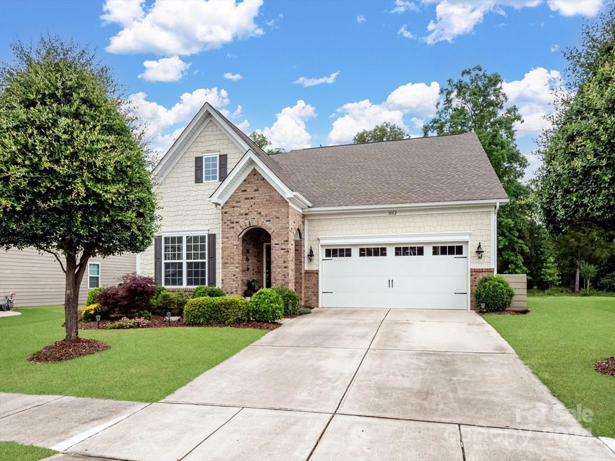 Welcome to this charming home situated against a backdrop of lush woods. A picturesque brick arched entryway leads you to the front door, step inside to discover versatile spaces like a formal dining room or study. Conveniently, the laundry is located downstairs, enhancing daily ease. Enter the kitchen boasting stainless steel appliances, granite countertops, and a central island overlooking the living room with its cozy gas fireplace and adjoining breakfast nook. Retreat to the primary bedroom, featuring a shiplapped trey ceiling, along with an en suite bathroom offering indulgence with a walk-in shower and a luxurious soaking tub. Upstairs, three additional bedrooms and a full bathroom provide ample accommodation for family or guests, while a loft area offers a versatile space for relaxation or entertainment. Outside, a porcelain tile patio awaits, complete with a sitting wall for alfresco enjoyment. The exterior has been thoughtfully refreshed with a recent paint job.