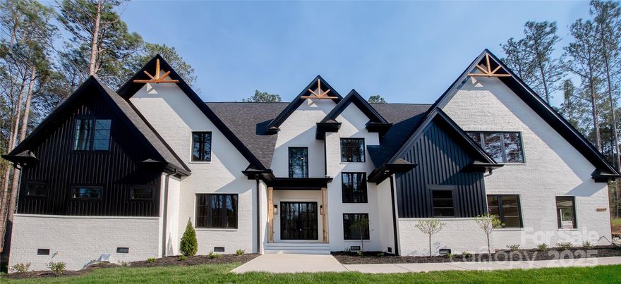 Experience true elegance in this exquisite newly built home offering over 4,000 square feet of luxury living. This 4-bedroom, 3.5-bath masterpiece is designed with impeccable attention to detail and the finest high-end finishes throughout. From 26’ ceilings and expansive windows to wide-plank hardwood floors and custom millwork, every inch speaks sophistication. The gourmet chef’s kitchen features Thermador appliances, quartzite countertops, and 2 oversized islands, perfect for entertaining. Retreat to the lavish primary suite with spa-inspired bath and generous walk-in closets. Additional highlights include a formal dining area, wine room, and a spacious great room with a statement fireplace. Step outside to a covered patio and sprawling Trex deck ideal for year-round enjoyment. This hand drawn home is built to impress and crafted for comfort, delivering an elevated lifestyle in every way. Schedule your private tour today and experience the height of luxury living.