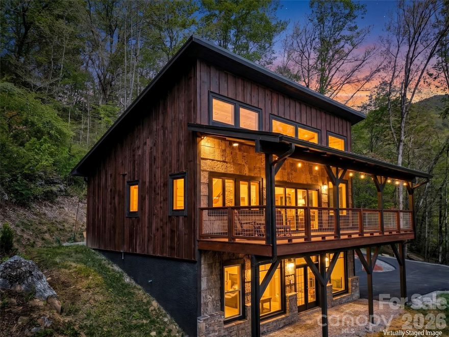 Adventure & Nature Lovers—This Is the Home for You!Live surrounded by everything you love in this stunning modern mountain escape, ideally located just minutes from the Blue Ridge Parkway.This beautifully crafted 2-year-old home features two spacious en-suite bedrooms, each with walk-in closets, thoughtfully positioned on separate levels for added privacy. Both bathrooms showcase large glass-door walk-in showers, offering a sleek, spa-like experience.The open-concept living area is filled with natural light, thanks to massive windows that bring the outdoors in and highlight the home’s breathtaking surroundings. Step outside to enjoy a brand-new asphalt-paved driveway and a generous covered front porch—perfect for taking in year-round views of Cold Mountain. Unwind in the evenings as you listen to the soothing sounds of the nearby creek and watch the sunset over the mountains.
The exterior boasts distinctive BarkClad natural and synthetic bark siding, adding a elevated rustic charm and setting this home apart from the rest.The main-level bedroom also includes access to a third-level loft, offering endless possibilities—whether you envision a home office, creative space, or cozy retreat. Currently, the large flex space on the lower level is housing a competition-grade pool table. With the high ceilings and the and wide open layout this can be the most versatile retreat. A blank canvas for your imagination to run wild with possibilities. This home is an absolute must see!