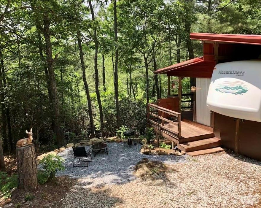 Great location one mile off the Blue Ridge Parkway. Reconnect with nature at this serene mountain getaway. Property includes a covered camper and large deck with an outdoor shower/soaking tub. Near the historic Altapass Apple Orchard, Linville Falls winery and hiking galore. The sky is the limit. This is a great piece of property to use a summer retreat and/or a rental. It is possible to remove the camper if buyer would prefer.
