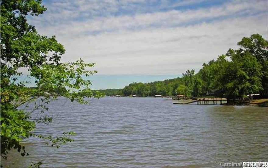 Country Mountain like setting on the water but minutes from the new Outlet Mall, Airport, and Interstates. Enjoy the privacy of having no restrictions of an HOA or fees yet the homes surrounding are well maintained and some  over a million dollars. This property has big main channel sunrise views and at the mouth of the cove so you are protected from the wake. Lot is perfect for a walk out basement home with great views from upper and lower areas. Priced to move FAST! Call now.