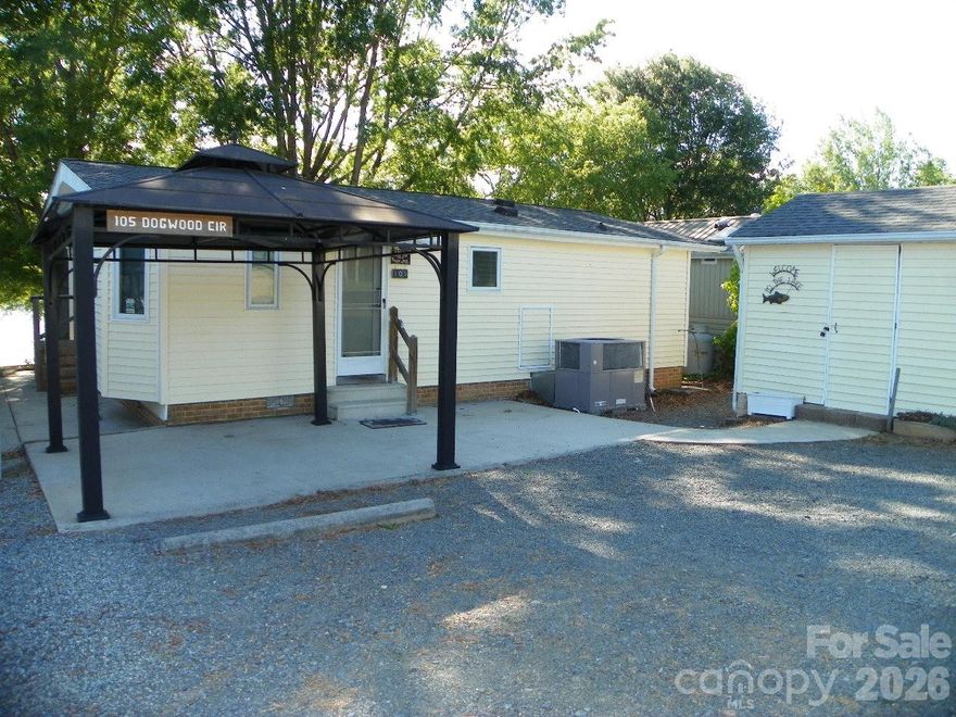 WATERFRONT-Property located in beautiful Gated(24 hr.)- Badin Shores RV Resort with Amenities for the entire family!!! AND Badin Shores own drop off and pickup mail room! Clubhouse with covered back deck-may be reserved by owners.  Make this YOUR permanent dwelling OR Lake Getaway- 2 Bedrooms, 1.5 baths, ceiling fans, eat at bar/kitchen, New stove and refrigerator remain. Great living room with a wall of windows/sliding doors to view beautiful Badin Lake!!! Covered (concrete) lakeside porch (items on the porch remain), Gazebo on road side- just sit and relax!! Storage building on the roadside -has washer/dryer in it remains. Just steps away from the Marina- Restaurant/boat launch/ boat slips and the beautiful sandy beach/picnic area.   Property comes with boat slip-134 H-30'. The slip is currently leased out by the owner till 3/15/27.
Extra Parquet flooring in the storage building, extra Vinyl siding under house. A little TLC and make this YOUR retreat !!  No gas tank-owner carries his own gas for heating.