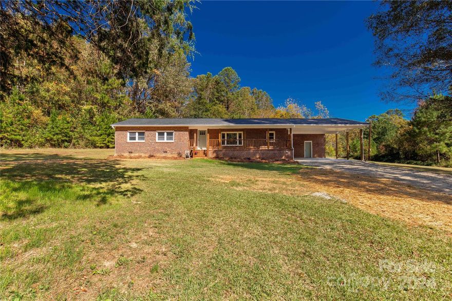 Welcome home to 1208 Smith St! This beautifully remodeled all-brick ranch home is situated on a spacious 1-acre lot. As you arrive, you'll be captivated by the charming front porch, which is both inviting and warm!

Inside, you'll discover stunning new luxury vinyl plank (LVP) flooring, a stylish color palette, and ample space throughout. The original brick fireplace serves as a focal point in the lovely kitchen and hearth room combo, enhanced with elegant wooden ceilings. The kitchen features granite countertops, white cabinetry, and stainless steel appliances.

The secondary bedrooms are generously sized, while the primary bedroom boasts an en-suite private bathroom with dual vanities. 

Step outside to find a covered 2-car carport area, complete with a storage room for your holiday decorations. With a 1-acre lot, there is plenty of space to spread out and enjoy the peaceful sounds of country living!