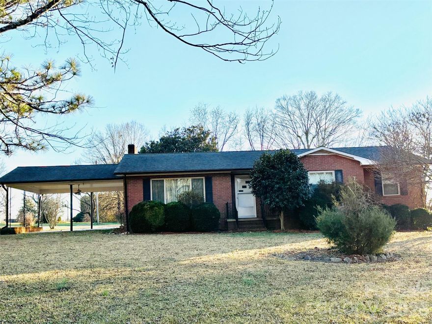 HOUSE WITH ACREAGE! PRIVACY AT ITS BEST! Welcome to this 3 bedroom, 2 bath brick home nestled on 2 acres with an additional est. 10 acres in separate parcels.  This is a one of a kind property! If you are looking for a home with LAND conveniently located to a grocery store, restaurant and more this is it! The den has beautiful wood walls with a fireplace. There is a spacious living room which could also be used for the dining room.The kitchen has white wood cabinets with linoleum floors. Beautiful pasture land with gorgeous sunsets! The property to the left of the house has an old homeplace on it with a septic . There are 4 additional parcels with included in this listing which connect to Skyland Dr in the CARTERS FARM  subdivision. There is also a large tractor/shed with a lean-to and another smaller shed on the property.Make an appt. today.