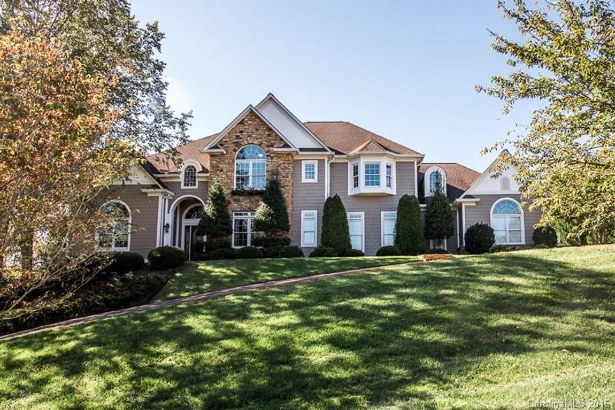 Move-in ready Governors Harbour home! Stone, hardcoat stucco & cedar exterior on level, double lot. Main level features open floor plan with 2 story foyer, great room, formal dining, kitchen with sunroom, guest suite, laundry room, screened porch & triple garage. Main level master suite has bay window, tray ceiling, newly remodeled bath & walk-in closet. Second floor has 3 bedrooms, 2 baths, bonus room, loft & walk in attic. Basement features bedroom, bath, den, side entrance & tons of storage.