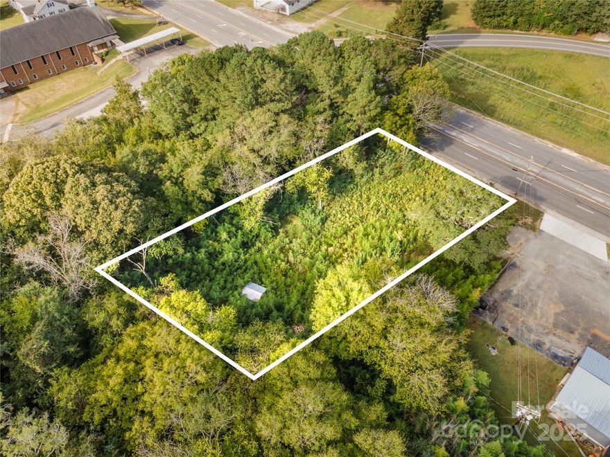 Prime commercial lot off busy Highway S 200!! For a business, this lot provides a terrific location and excellent visibility. This parcel has county water connected, an electrical box onsite and county sewer available (tap fee required). Minutes away from major roadways, shopping, business centers and MORE! Zoned for General Business, this parcel offers endless opportunities to build or to invest. Storage shed on property is included. Trees on property are a mix of hardwoods AND bamboo! GREAT VALUE - MUST SEE and easy to walk!