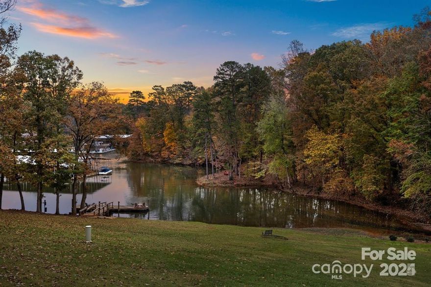 WATERFRONT! End unit Condo on Lake Wylie w/year around water view & beautiful sunrises from your back decks or a short walk to the private community dock. River Hills is a gated community with tons to offer!  The cove at condo is the perfect place to launch your kayak!  Or if boating is your thing, there is an easy trail through the woods to the marina and the beach at lake.  Let's not forget the community pool!  It’s a short walk!  Once you step inside you will be welcomed by a lovely renovated chef’s dream of a kitchen, which is open to the dining room & great room w/wet bar! Water views from inside in numerous locations. A bedroom on the main level is an added plus w/renovated hall FULL bath! Private primary suite is upstairs has amazing water views! Waking up & seeing the sunrise over the water is a great way to start your day! Wait until you see the totally finished & renovated basement w/water views in front bedroom & family room plus the scenic views from the lower level patio.