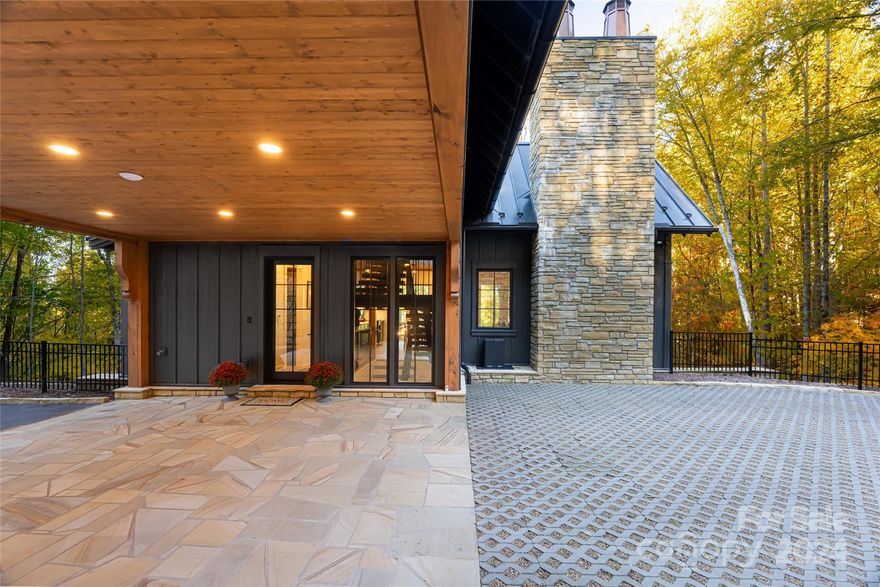 Perched 4,000 feet in the heart of the Blue Ridge Mountains, this remarkable offering presents a rare opportunity to experience elevated mountain living within Balsam Mountain Preserve in Sylva, North Carolina. A luxurious Morgan-Keefe Custom Built fully appointed, move-in ready exquisite house—equipped with EV charging—is already in place, while across a running mountain stream, your dream home site awaits. This exceptional property allows you to step immediately into the Balsam lifestyle—tee off at the Arnold Palmer-designed golf course, enjoy scenic horseback rides from the equestrian center, and unwind at the private wellness center—all within a gated community defined by privacy, natural beauty, and refined amenities. Ideally suited as a primary residence, secondary home, or legacy mountain retreat.

The quest residence is a sophisticated, fully furnished sanctuary where architecture and nature exist in perfect harmony. Expansive floor-to-ceiling glass frames the surrounding landscape, while the open-concept design creates an effortless flow for both entertaining and everyday living. A gourmet kitchen anchors the space, complemented by a vaulted living room and striking stone fireplace that invites year-round relaxation. A thoughtfully designed secondary suite, complete with its own private entrance and kitchenette, offers exceptional flexibility for STR /LTR/ multigenerational living, providing both privacy and income potential without compromise.

Across the stream, a premier homesite offers the opportunity to design and build a custom estate while enjoying immediate use of the existing residence. Significant infrastructure is already in place, including a 1,000-foot paved private driveway, high-speed fiber internet, generator, high-capacity deep freshwater well, and power pre-plumbed to the main building site. This is a rare convergence of immediate livability and future vision—an extraordinary opportunity to create a legacy property within one of Western North Carolina’s most sought-after private communities.