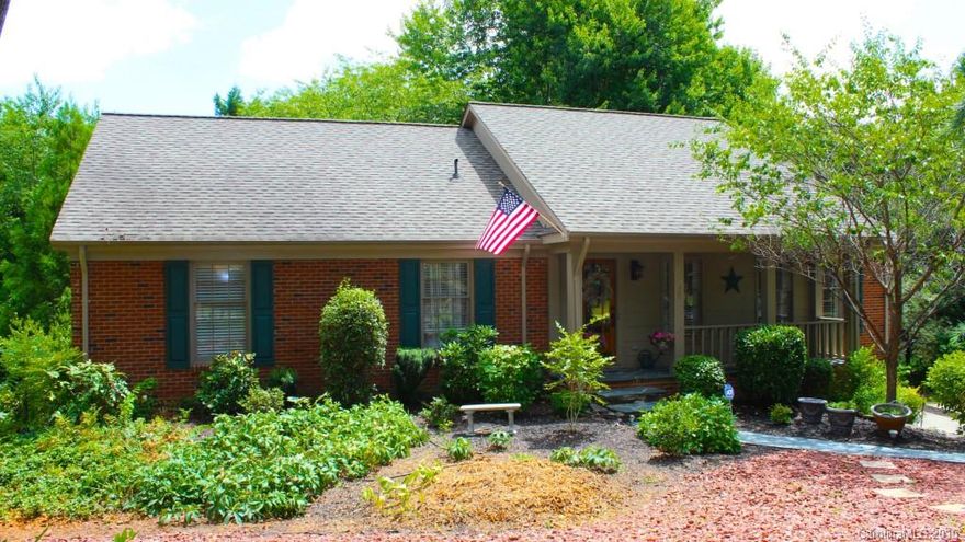 A Ballantyne Oasis! Surrounded by nature, this charming all brick ranch/basement home sits ideally near the cul-de-sac of a quiet street. Welcoming rocking chair front porch. Recently remodeled kit. with Silestone countertops and exquisite cabinetry. Enjoy the wood burning FP. Large formal LR/DR with gorgeous wainscoting. Huge  rec room down with 1 BR/BA has endless possibilities. Build a fire and relax by a peaceful koi pond or entertain on your two level massive deck. Hurry, this won't last!