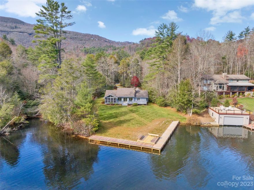 Beautifully renovated 3BR/3BA one-level home on magnificent 1.34 acre flat lakefront site with an additional small, private pond.  This move-in ready home is offered fully furnished and features an open, light filled floor plan with a long view down Lake Toxaway's fabled Skier's Cove, newly completed lakefront boardwalk and seating area, large bonus room with newly installed heating system, hardwood floors, granite countertops, stone wood-burning fireplace, relaxing screened porch overlooking the lake, and flat backyard for many happy memories to be made.  This is a must see home and won't last long.