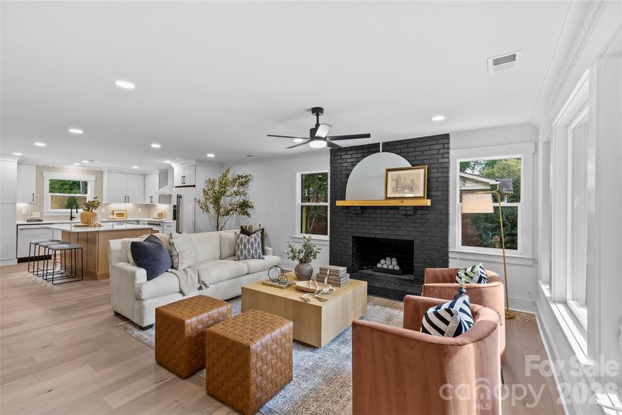 Welcome to 2461 Eaton Drive, a remarkable reinvention in the heart of Amity Gardens—a charming community near Commonwealth, Oakhurst, and Cotswold, and just minutes from Charlotte’s Center City. This 1950s ranch has been fully transformed into a modern home with timeless curb appeal, featuring true full cedar porch columns that set the tone for the craftsmanship inside. Taken down to the studs, the home boasts all new wiring, plumbing, insulation, drywall, windows, HVAC, tankless water heater with recirculating pump, and an architectural shingled roof. This is essentially a brand-new build wrapped in the charm of an established neighborhood. Inside, a wide-open floor plan creates effortless flow between the living, dining, and kitchen. White oak engineered hardwood floors run throughout, lending warmth to the home’s contemporary modernist aesthetic. The living room centers on a stylish fireplace with gas ceramic ball set, anchored by a cedar mantel—a perfect gathering spot for everyday living. The kitchen is sleek and functional, appointed with quartz countertops, modern cabinetry, and designer finishes. Bathrooms mirror the same quality with quartz vanities, stylish tilework, and carefully curated details. A rear entry drop zone with a cute bench and storage makes everyday life easy, while a full-size laundry room offers true convenience. The huge primary suite is a standout retreat, designed with vaulted ceilings, generous proportions, and a spa-like en-suite bath. Two additional bedrooms, each with its own private bath, provide flexibility and comfort. Outdoor living is just as appealing. The welcoming front porch overlooks the neighborhood, while the 16’ x 16’ Trex deck offers a spacious, low-maintenance spot for entertaining or relaxing. The fenced backyard creates a private escape for pets, gatherings, or play. Every detail has been thoughtfully considered to create a warm yet sophisticated home, blending clean modern design with timeless materials. With its complete rebuild, elegant finishes, and inviting layout, this home is truly move-in ready. The location is just as impressive—nestled in Amity Gardens with quick access to Commonwealth, Oakhurst, and Cotswold Village for dining and shopping, and only minutes to Plaza Midwood and Uptown. 2461 Eaton Drive is more than a renovation; it is a reinvention—an opportunity to own a one-of-a-kind home that combines modern comfort, warm style, and unbeatable convenience.