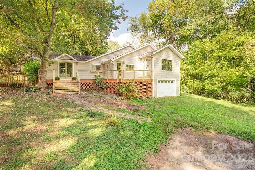 Tucked away down a private drive, this charming Oakley bungalow welcomes you with vaulted ceilings, exposed beams and beautiful knotty pine ceiling planks.  You'll be greeted by coziness and warmth, with fresh paint accentuated by beautiful wood trim throughout.  The thoughtfully designed (and permitted) en suite primary bedroom addition has its own mini-split system, creating a private sanctuary bathed in natural light.  Access the brand new deck from both bedrooms and the main living room, where you can sip your morning coffee and listen to the birds among the mature trees.  Just a short drive to Tunnel Rd shopping, highway access and downtown, you have the best of both worlds!