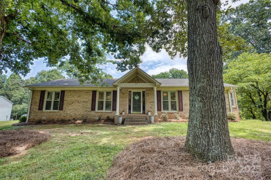 HERE IT IS! The charming brick ranch with back yard bliss you've been looking for! This well-maintained 3 Bed, 2 Bath brick home delivers classic style with a twist of rustic charm. Inside, a perfectly symmetrical living room boasts cathedral ceiling, a statement stone fireplace, and dual French doors that lead out onto the covered deck with a large TV - ideal for game days or laid-back evenings. Out back, enjoy a sparkling in-ground pool and a generously sized detached 2-car garage/shop. It's the kind of home that makes weekends feel like a getaway!
