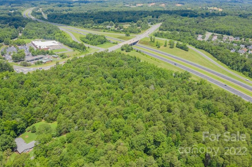 15.7 Acres.  Can be subdivided. Close to speedway.  High Visualbility off of I-485.  Close to shopping - Across the street from Cambridge Common Shopping Center. Be sure to check out the video under media.