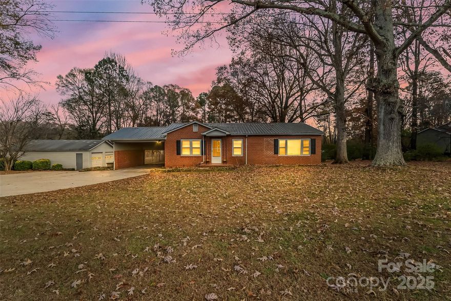 Charming and move-in ready in Maiden! This wonderful brick ranch home offers 2BR/1.5BA, a large detached garage for the ultimate hobby space and is in the desirable Maiden school district! Nestled on an acre of land and surrounded by mature trees, this home offers fresh paint and beautiful floors. Living room is spacious with large windows. Kitchen features white cabinetry, ample counter space and a large eat-in area. Both baths have been updated. The large deck overlooks the private backyard. Carport off the home along with a large driveway, perfect for parking multiple vehicles. Large two bay detached garage features shelving and ample storage space. Additional storage shed to remain. Maiden Elementary, Maiden Middle and Maiden High school district.