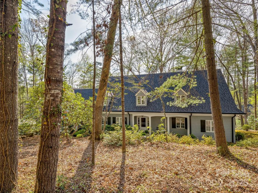 Capture this rare opportunity to own a stylish traditional home by famed architect Henry Gaines. It features gracious main level living and an upper level for family or guests. Lovely details of wide board flooring, beams, fine mill work and builtins within a highly livable floor plan will offer you an abode for your life well lived. Walls of
windows in the warm sunroom offer views of the wooded grounds accented with native landscape. A delightful
stone terrace offers an inviting space for relaxation or entertaining. The primary bedroom on the main
level features an updated bath. Upstairs are a gathering room and two ensuite bedrooms. Every room is
spacious and well appointed, The wooded lot is private, sunny and low maintenance.  Sited deep in the
Forest the home is a stone's throw from the fabled Biltmore Estate. It offers a highly walkable
neighborhood with a membership Country Club and a private pre K -12 school. Nearby is shopping, dining and the Mountain to Sea Trail