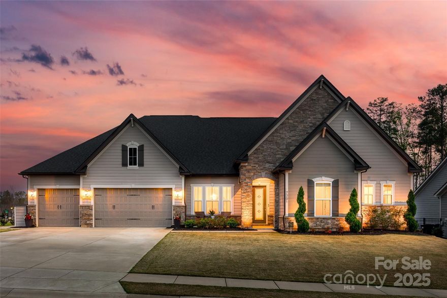 This stunning ranch home offers luxury and comfort with soaring 11-12 foot ceilings and a bright, open floor plan, filled with natural light. The gourmet kitchen features upgraded appliances, 42-inch cabinets, and elegant heavy crown molding and tall baseboards throughout. The large primary en suite serves as a private retreat, along with three additional spacious bedrooms. Step outside to an outdoor fenced in living oasis with a custom in groud, heated, salt water, gunite pool/spa combo perfect for relaxation or entertaining. Pool depth goes from 3 to 6 feet. Just steps outside of the pool you will find the covered outdoor kitchen with a large stone fireplace to keep you warm.  The three-car garage provides plenty of space for vehicles and storage. Located in an area with low SC taxes and award-winning schools, this home combines elegance, functionality, and a high standard of living. Experience the best in luxury living today!