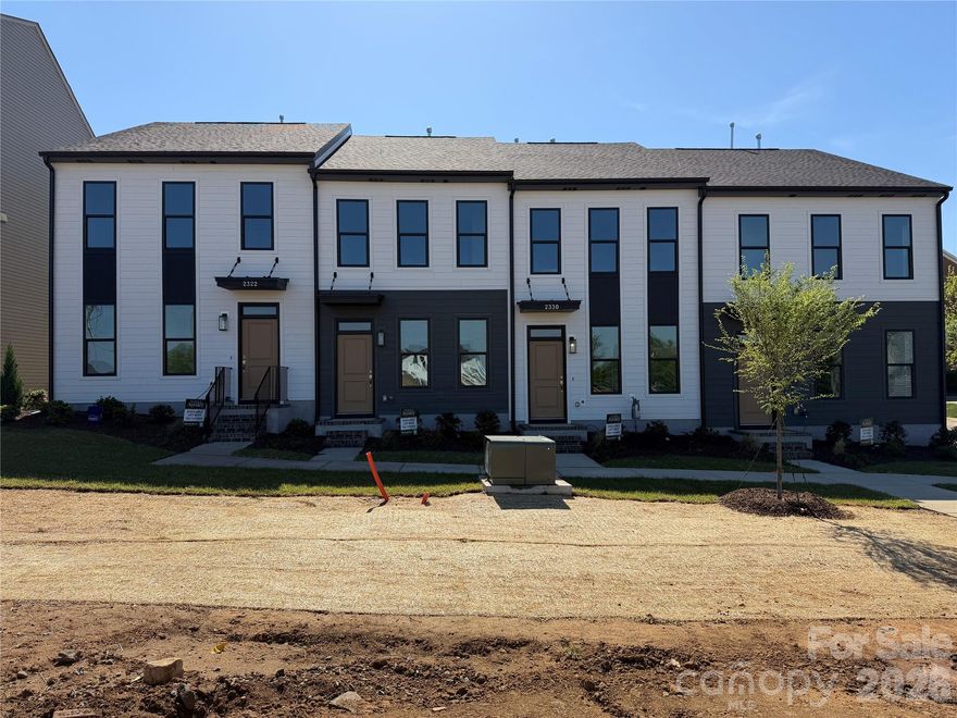 MOVE-IN APRIL. Discover effortless living in The Greens at Ayrsley, a new townhome community set in one of Southwest Charlotte’s most walkable and vibrant neighborhoods. Step outside your door and into a lifestyle where over 20 restaurants, coffee shops, fitness studios, boutique retailers, and a movie theater are all just moments away. Whether it’s dinner with friends, a morning workout, or an evening out, everything you need is right here.
The Arlington plan offers a thoughtfully designed two-story layout that blends comfort and style. A private first-floor bedroom with full bath creates the perfect space for guests or a quiet home office, while upstairs, an open-concept living area invites connection and ease. The kitchen serves as the heart of the home, anchored by a generous island and seamlessly flowing into a bright, welcoming living space. The primary suite provides a peaceful retreat with a spacious walk-in closet and a well-appointed bath.
Carefully selected finishes bring warmth and sophistication throughout, complemented by durable flooring, elevated cabinetry, and timeless details. A rear-load garage adds convenience with additional parking, while the low-maintenance design supports a lock-and-leave lifestyle.
All of this, just minutes from major highways for easy access across Charlotte. Backed by a 2-10 Home Warranty. Ask about available down payment assistance available through our preferred lenders and experience a new way to live at Ayrsley.