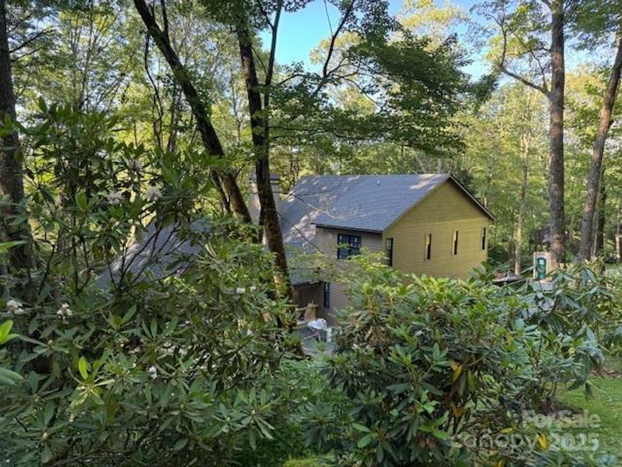 Luxury New Construction in Cullasaja Club – Completion July 2025! Expanded to include a four-season den with fireplace and a larger rear deck, this 3BR/3.5BA home blends luxury with mountain serenity. Nestled on a peaceful, wooded 0.8-ac lot just minutes by foot or golf cart to the Clubhouse, pool, golf, and tennis. Cathedral ceilings, a fireplace, and soaring windows highlight the great room. A chef’s kitchen features high-end appliances, custom cabinetry, and open flow, perfect for entertaining. The main-level primary suite offers a spa-style bath and walk-in closet. Two ensuite guest rooms located upstairs. The unfinished walk-out lower level has high ceilings and is plumbed for a full bath—ideal for future expansion. Premium finishes have been selected, with time to customize. With membership approval, enjoy golf, tennis, croquet, fitness, pool, dining, social events, and a private lake for fishing and kayaking. A gentle stream through the backyard completes this mountain retreat.