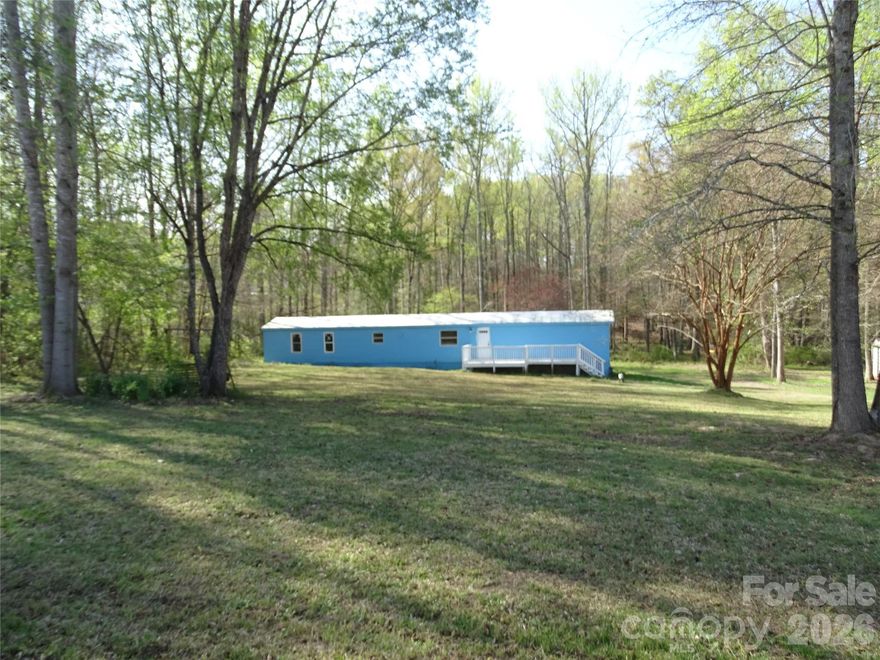 Looking for a weekend getaway, a vacation spot near the lake, or add to your rental portfolio. This singlewide has a 1.54 acre lot with a lakeview from the back yard. Lake access is not that far away off of Hwy 8. Split bedroom floorplan, tile in kitchen, no carpet, large front deck. There is a storage building that will remain. Selling as is. New tax value will be 179,200. Back portion of the lot is in the flood zone, due to being at the lake. The boat launch area is 3.6 miles away or approximately 7 minutes away to the Wildlife Recreation access. (Photos of the boat launch area at the lake are located at the last of the photos) CASH OR CONVENTIONAL LOANS ONLY.