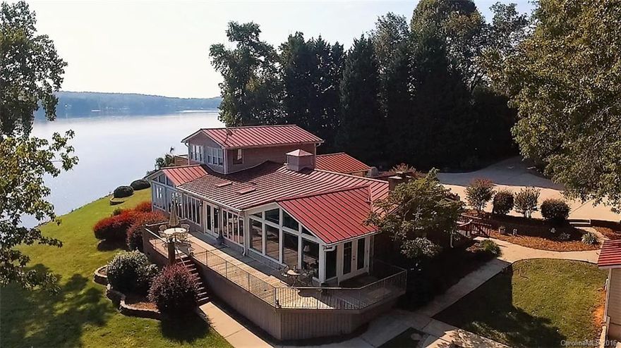 SPECTACULAR WATERFRONT!!! 180 degree views of the main channel on Lake Wylie. In ground pool overlooks the lake with outdoor kitchen and cabana. Open floor plan and spacious kitchen with SS appliances and granite counters. First floor master with great views, gas log fireplace and sun/sitting room. Large first floor recreation room has fireplace and opens to pool. Detached garage has two rooms on second floor with full bath. Dock with boat lift. Lake life minutes from dining/shopping and Uptown.