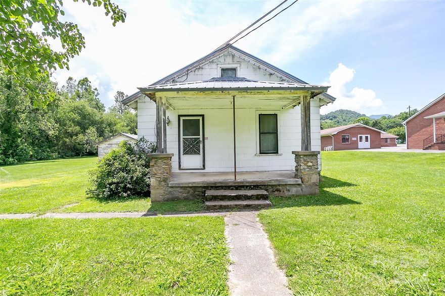 Home + 2.239 acres located in the growing and inviting Hazelwood Business District! This prime creekfront opportunity awaits for those with vision! Do you LOVE a good renovation project? You will delight in the wood floors and true potential found in this quaint 1930s home. Mature trees and bamboo groves line the creekside and back of property. Waynesville is GROWING, and this spot is the perfect place for an exciting business venture or residential development. The Town of Waynesville has confirmed this lot can be used as residential OR commercial. See survey in photos to show the property lines. Additional parcel across the road is also listed, as is both parcels combined.