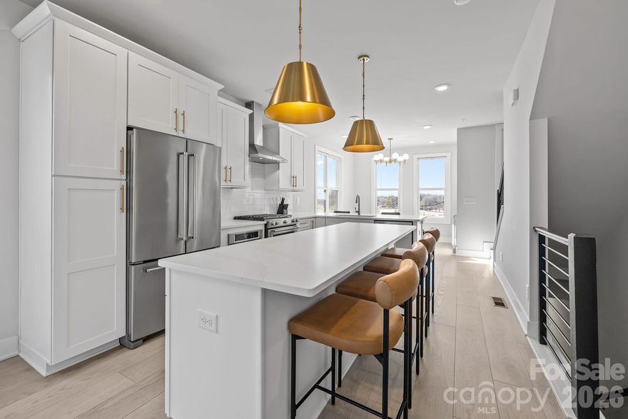 Experience elevated South End living in this exceptional 2023-built end-unit townhome, offering 3 bedrooms, 3.5 bathrooms, plus a versatile fourth-level retreat. Flooded with natural light, this residence showcases high-end finishes throughout, including a designer kitchen with a statement island, gas range with vented hood, built-in microwave, and dedicated eat-in area.

The primary suite features a custom closet system and a spa-inspired bath with designer tile selections. Upstairs, the fourth level provides a private full bedroom and bath, loft-style lounge, wet bar with beverage cooler, and access to a stunning sky terrace—perfect for entertaining or relaxing above the city.

Additional highlights include updated window treatments, an oversized tandem 2-car garage, and a premier South End location just steps to the light rail, shopping, dining, and entertainment. Ideal as a luxury residence or investment opportunity.