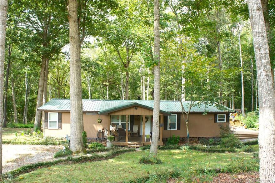 This beautiful double wide home sits on a 1.09 acre private wooded lot.  This 3 bedroom 2 bath comes with a large beautiful kitchen with tons of kitchen cabinets that flows comfortably to the breakfast area. Covered front porch, large rear and backyard deck, tree house and a detached garage!!! Just minutes away from Ballantyne restaurants,shopping. Low SC taxes! Home is sold AS-IS!!!