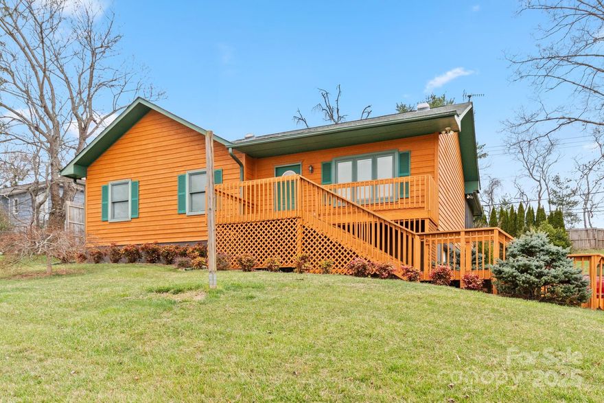 Situated on a peaceful and spacious West Asheville lot with distant mountain views, this well-loved and maintained property boasts 2 bedrooms (primary bedroom en-suite), 3 full baths, and a versatile basement space that can be utilized as a guest suite or family room. Generous eat-in kitchen, private and tranquil screened-in back porch, ample off-street parking. Radon mitigation already in place. Includes single car garage and adjacent workshop space.